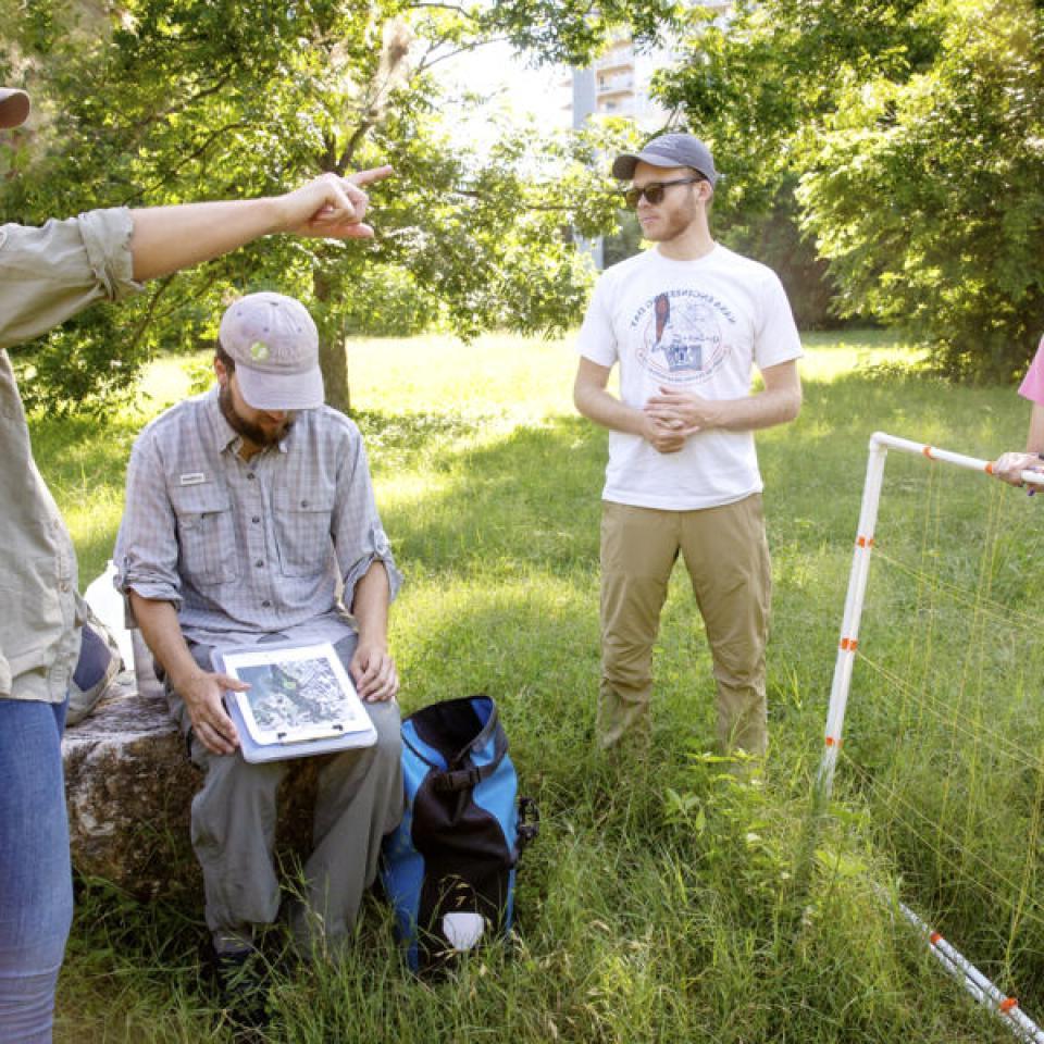 Stella Cunningham, left, listens to instructions for field work from teammates.