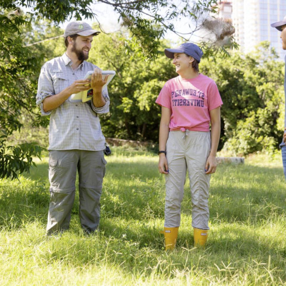 Stella Cunningham, center, talks with teammates while taking a break from field work.