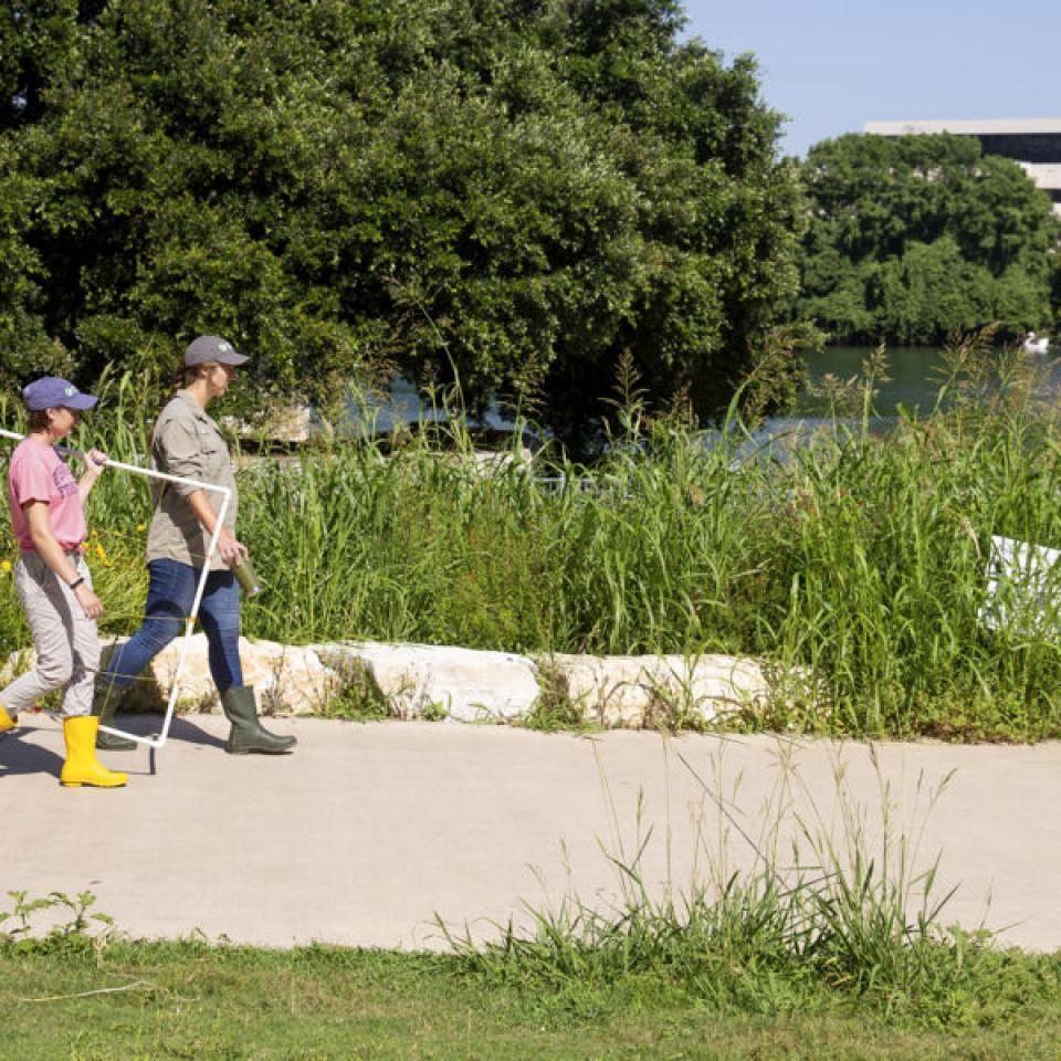 Stella walks with a teammate while conducting field research.