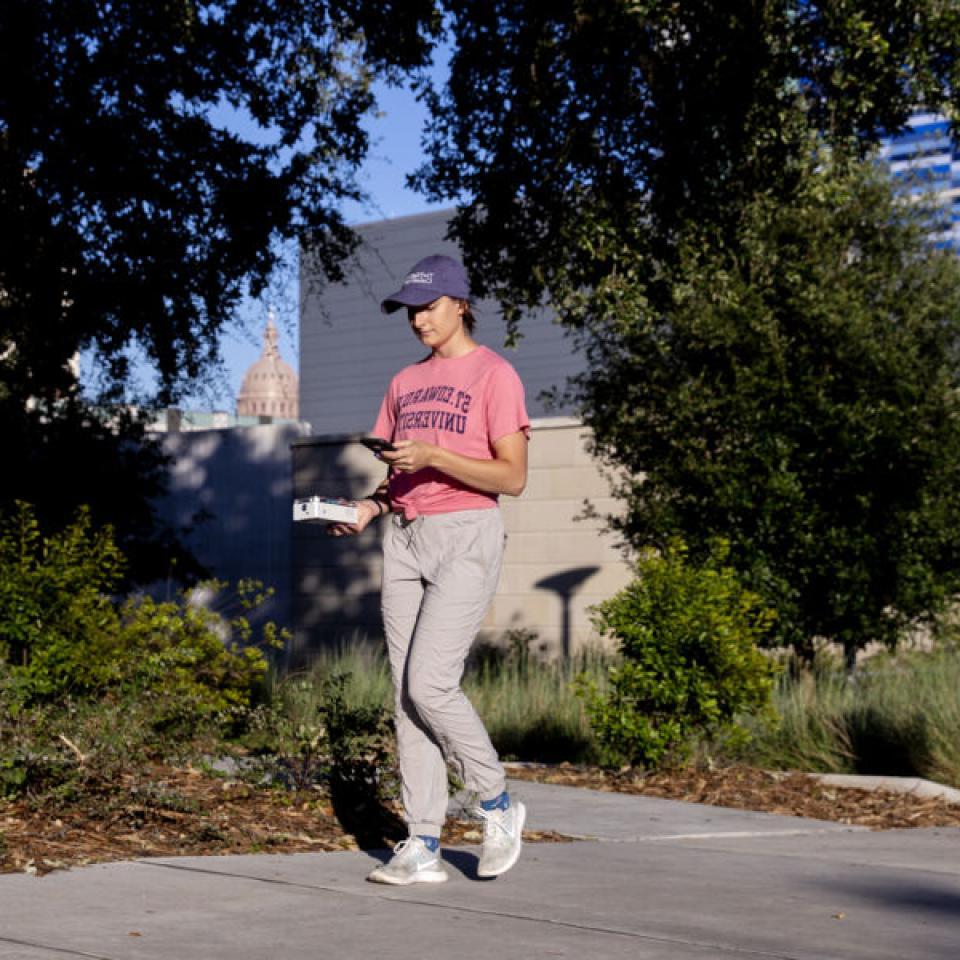 Stella Cunningham walks around downtown while doing field research.