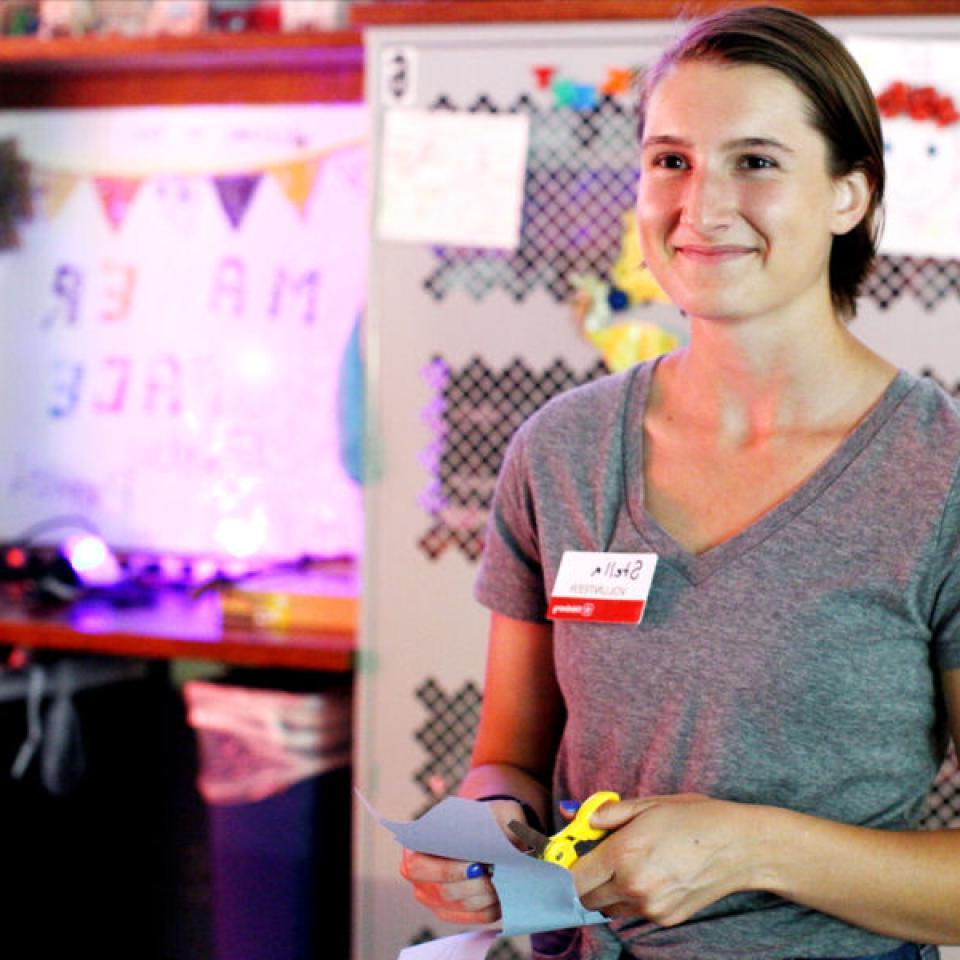 Stella Cunningham works on a craft while volunteering at the Thinkery.