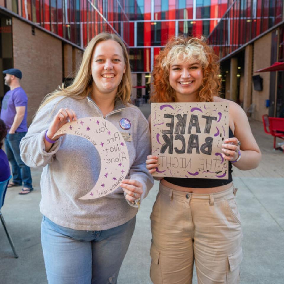 Students holding signs and participating in Take Back the Night event at St. Edward's.