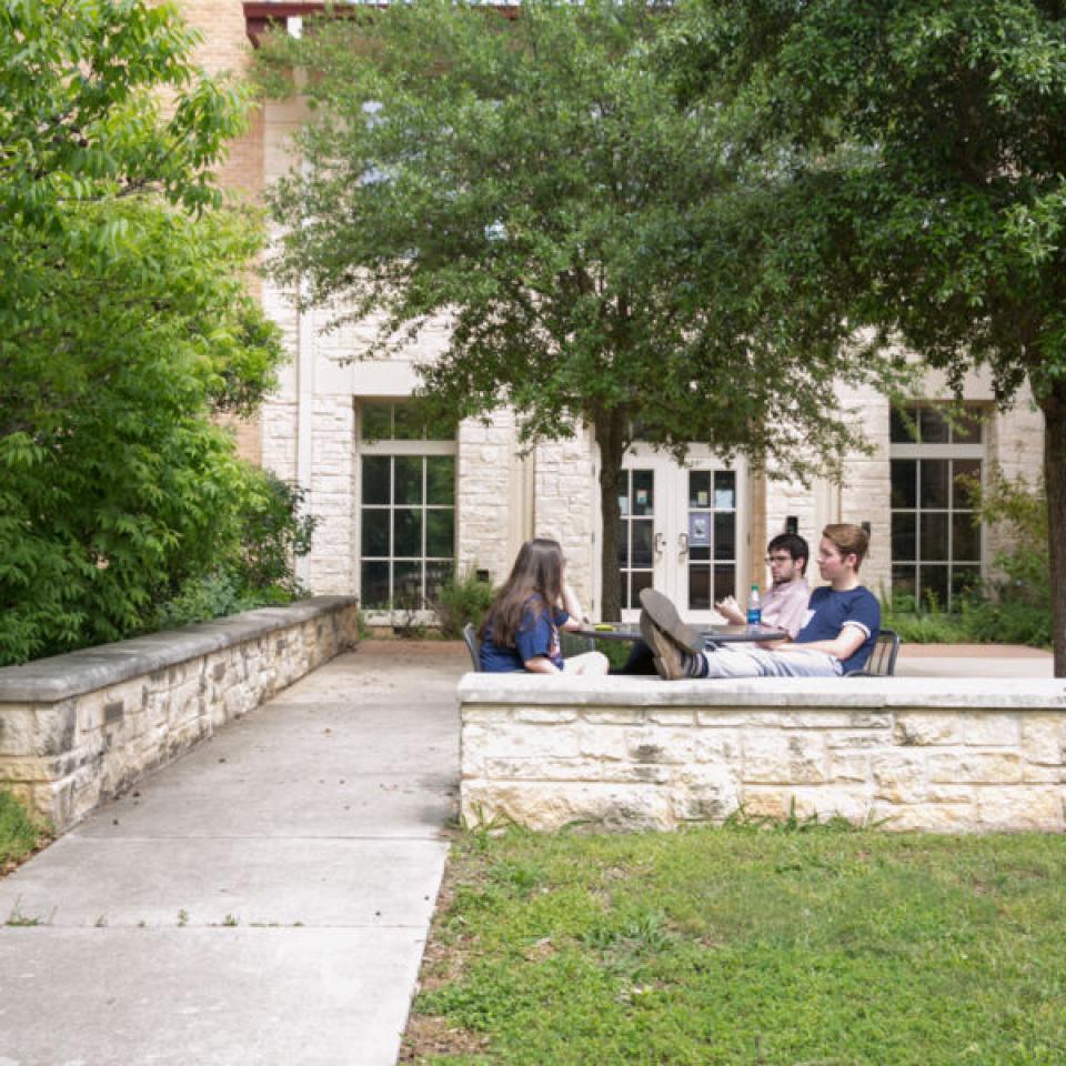 Students sitting outside Jacques Dujarié Hall