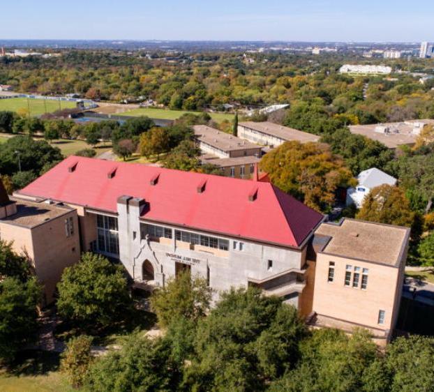 An aerial view of The Bill Munday School of Business and the downtown Austin skyline.