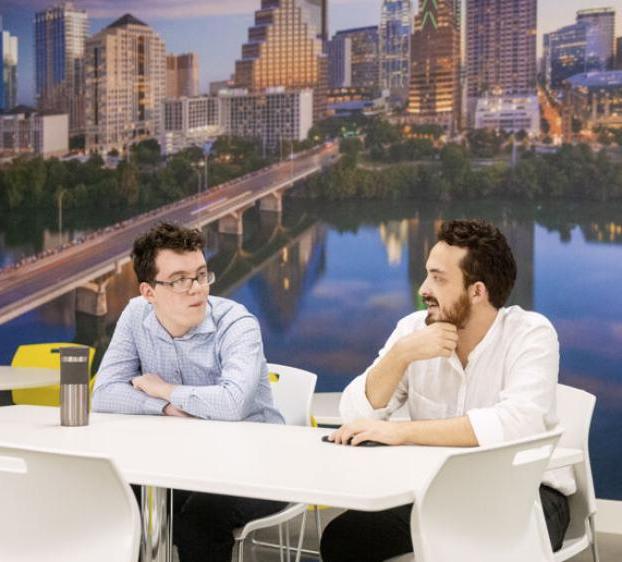 Two students work in an office in downtown Austin