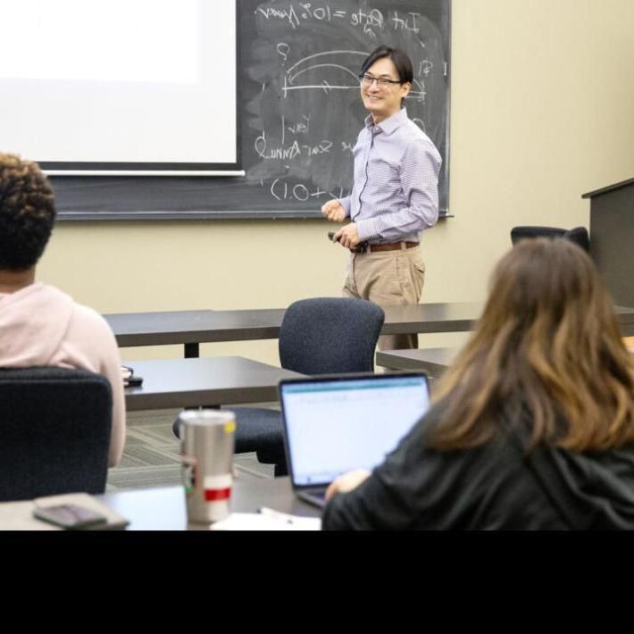 A graduate accounting professor teaches a class at St. Edward's University