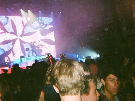 A large crowd and a stage with purple lights