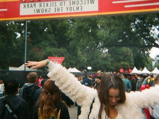 A woman dancing underneath the ACL entrance gates