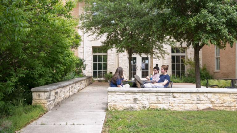 Students sitting outside Jacques Dujarié Hall