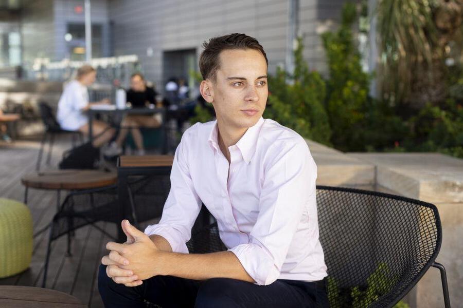 Christoph Hoermann sits in a chair on the rooftop patio of the Austin Public Library.