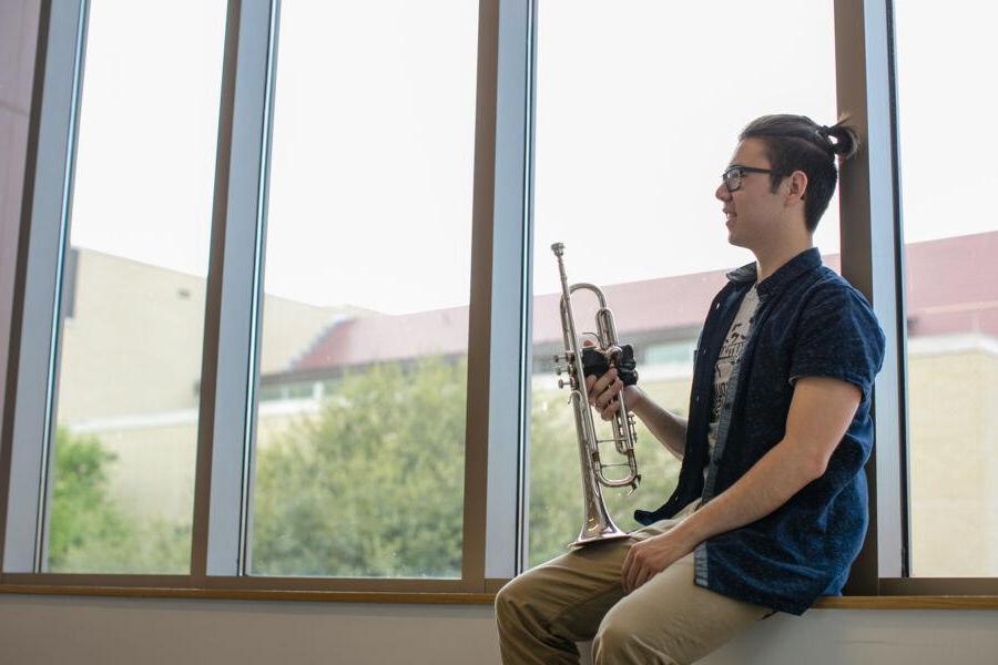 Chris jackson holding a french horn