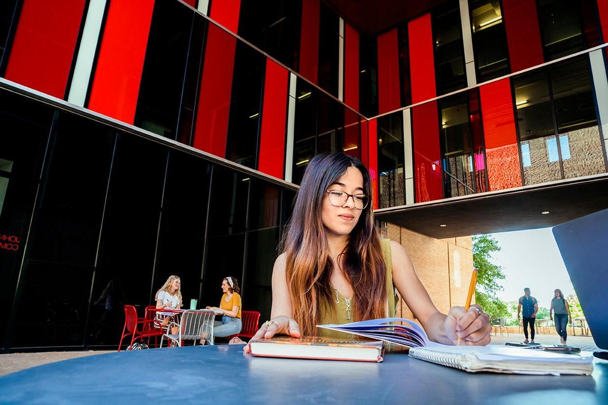 student sitting in patio